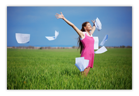 Woman happily tossing papers in the air outdoors